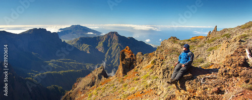 Resting man watching a landscape above the crater Caldera de Taburiente, Island of La Palma, Canary Islands, Spain photo
