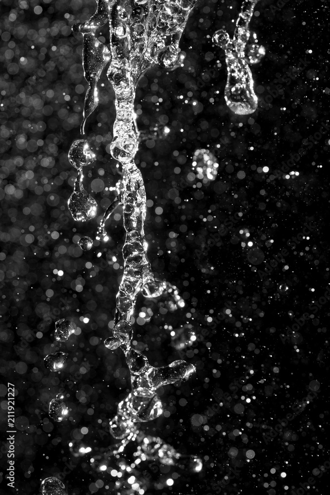 water jet with spray on a black background water jet with spray on a black background