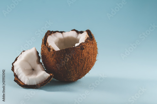 The cut coconut lies on a blue background. photo