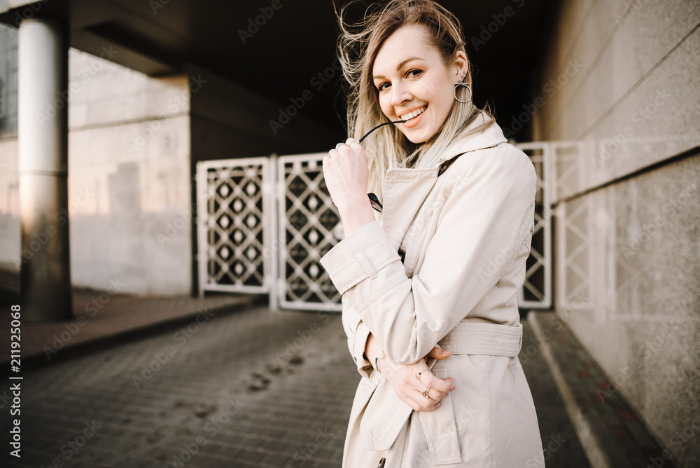 Fashion portrait of an elegant woman in a raincoat on the nature Fashion portrait of an elegant woman in a raincoat on the nature