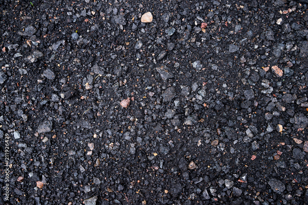 Black and gray asphalt with rocks background texture closup Black and gray asphalt with rocks background texture closup