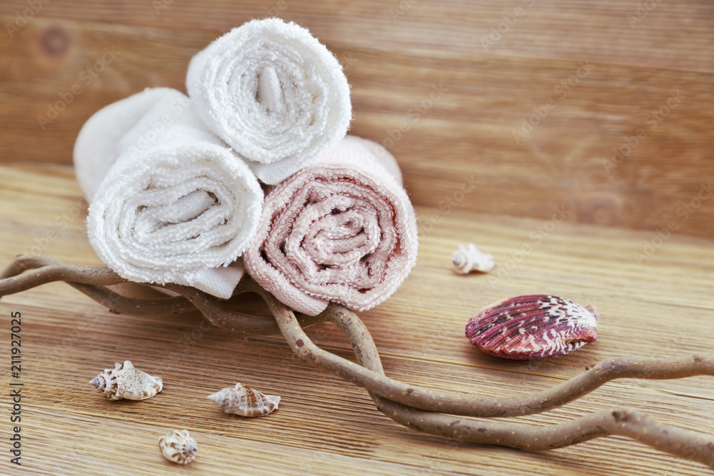 Pile of cotton towels on wooden background with copy space. Selective focus. Spa concept from natural items. Pile of cotton towels on wooden background with copy space. Selective focus. Spa concept from natural items.