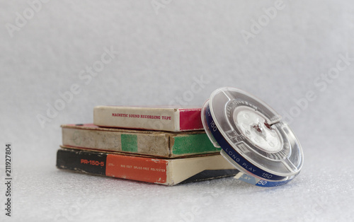 Isolated Old Style Magnetic Sound Recording Tape with Original Boxes (Package) on a white gray background
