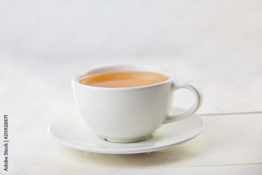 porcelainl cup with green tea on table