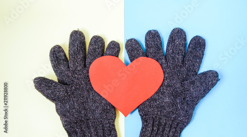 paper heart and winter gloves on isolated background