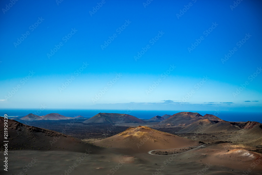 If it wasn't the Ocean, this would look like Moon scape. The vast emptiness and loneliness of the Lanzarote black frozen lava volcanic desert with few sleeping volcanoes and almost clear blue sky