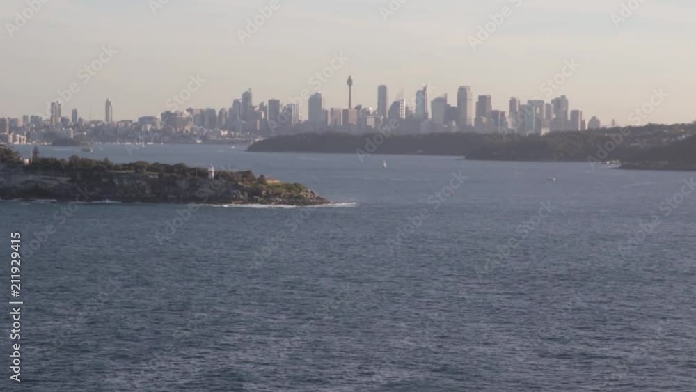 Beautiful establishing shot of Sydney Australia from across the harbor water on a hot sunny day Beautiful establishing shot of Sydney Australia from across the harbor water on a hot sunny day
