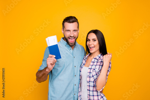 Fotografie Portrait of successful lucky couple getting visa abroad holding raised fist show