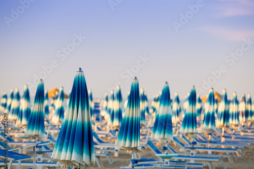Rimini. Italy. Beach umbrellas on blue clear sky background.