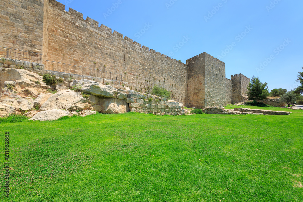 Grass lawn near wall of old city Jerusalem