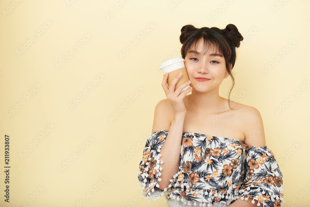 Studio shot of Asian girl drinking hot coffee Studio shot of Asian girl drinking hot coffee