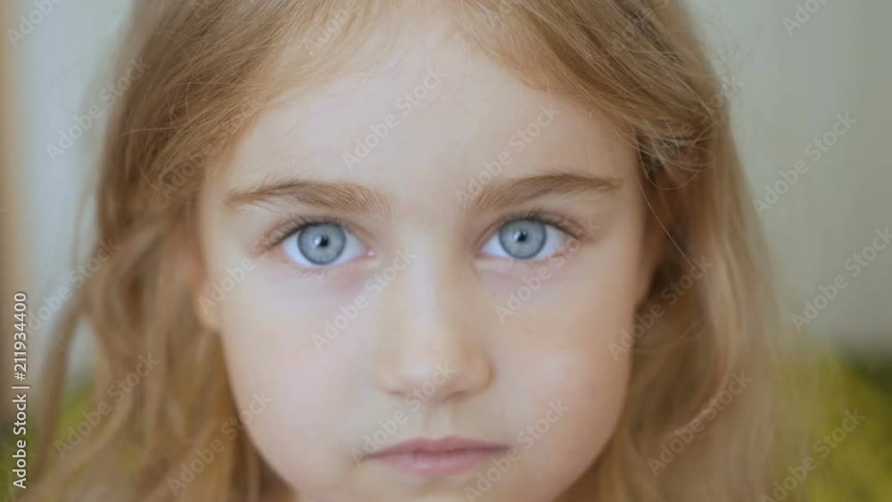 Portrait little young girl with blue eyes looking at camera Portrait little young girl with blue eyes looking at camera