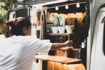 Selected focus drip coffee cup woman buying a coffee from a coffee food truck