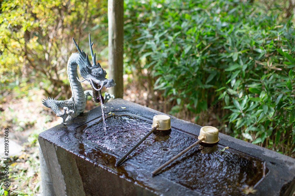 The Water Purification Basin temizuya or chozuya in Japanese temple. The cleansing hands and mouth ritual in Japanese temple or shrine. The dragon fountain. The Water Purification Basin temizuya or chozuya in Japanese temple. The cleansing hands and mouth ritual in Japanese temple or shrine. The dragon fountain.