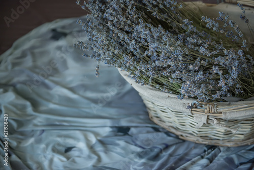 Fototapeta Naklejka Na Ścianę i Meble -  Basket with lavender on a gray fabric. Dark photo vintage style
