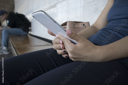 girl or female hands with white tablet in subway