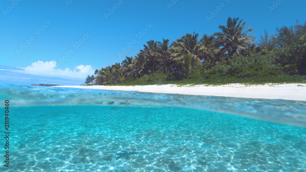 HALF UNDERWATER: Turquoise ocean water washes the breathtaking white sand beach.