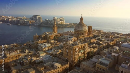 Valletta, Malta - 4K flying towards Mount Carmel Basilica and St.Paul's Cathedral above the ancient city of Valletta on a summer morning