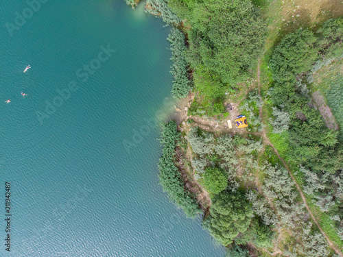 aerial view of azure water with green beach. tent on beach.