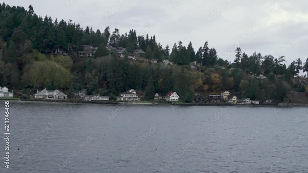 View of island houses from a ferry ride. View of island houses from a ferry ride.
