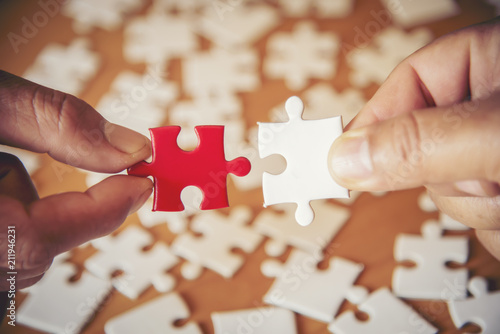 point holding connecting red and White ,Business connection,Success and strategy concept one finger , point pieces of jigsaw puzzle,Teamwork concept