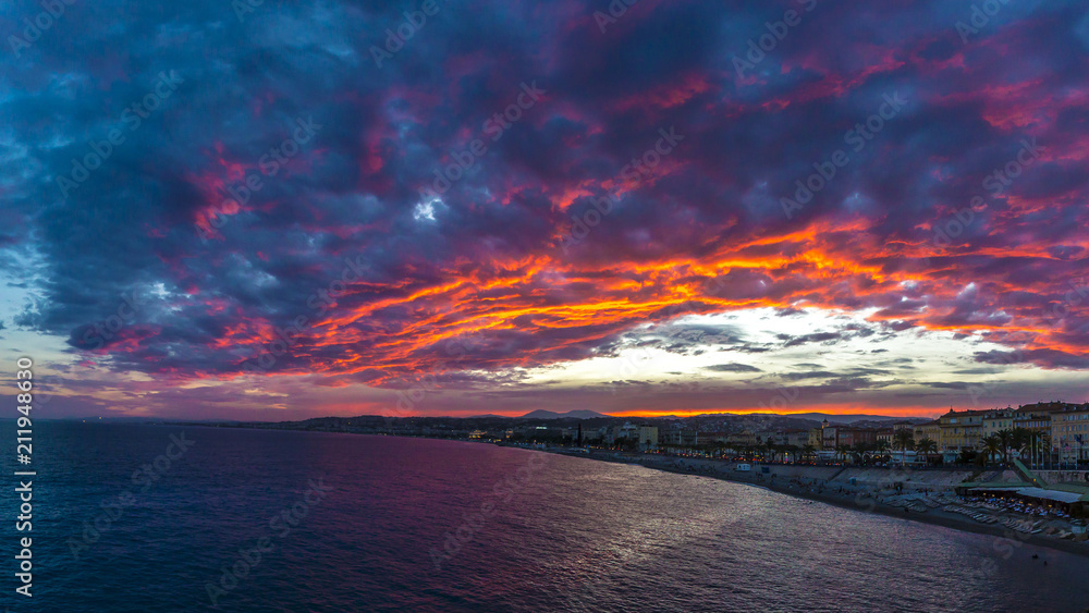 Stunning sunset and colorful clouds over the city and the coastline of Nice, France