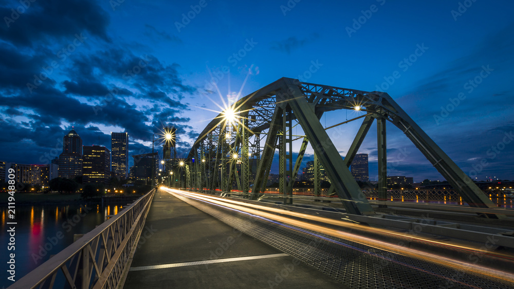 Hawthorne Bridge in Portland, Oregon, USA, at sunset, with city skyline in the background