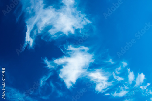 Deep blue sky with bright fluffy clouds. Scenic view at blue sky with clouds. Abstract nature background. Dramatic sky with fluffy clouds. Sunny day.