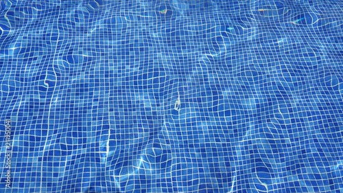Abstract of blue water in the swimming pool with a wave, background.