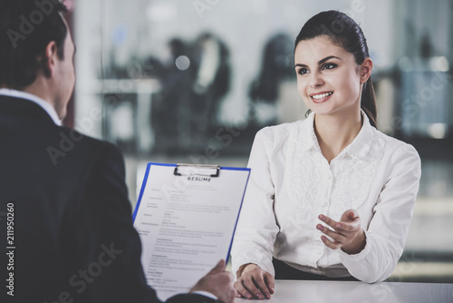 Businessman Taking Resume from Woman in Office.