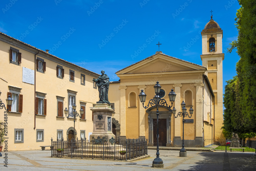 Bagnoregio, Italy - Annunciation Church and Saint Augustin statue in historic center of old town quarter at Piazza Sant’Agostino square