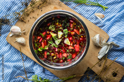 Cold soup Chrianteli with sour cherry or blackberry juice. Georgian traditional summer food with garlic, green herbs, cucumbers. Raw vegan vegetarian healthy food. photo