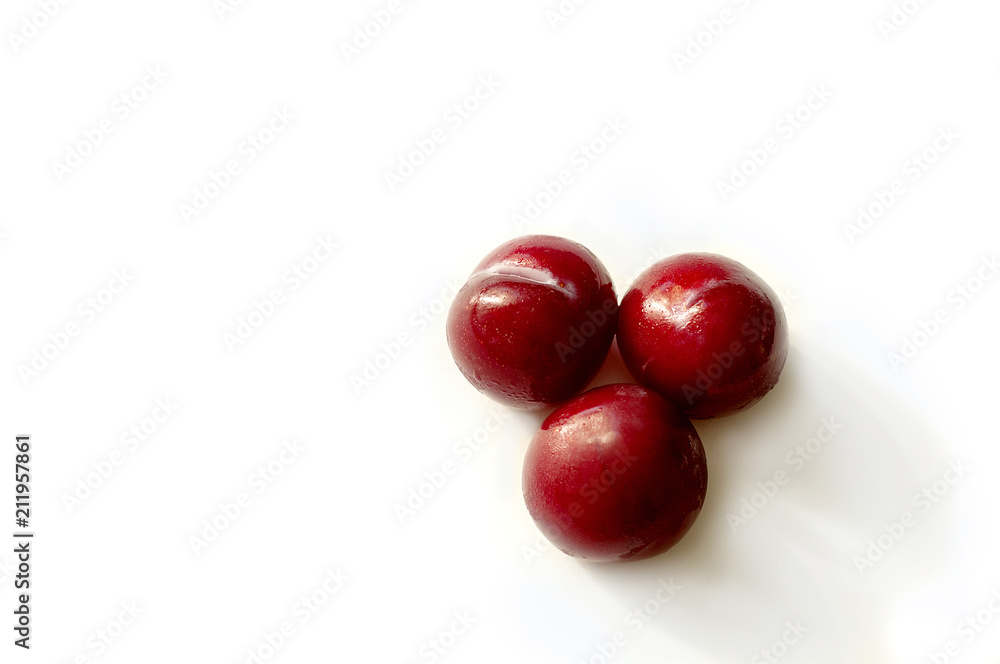 Red plum bright delicious juicy on a white background Red plum bright delicious juicy on a white background