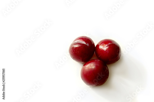 Red plum bright delicious juicy on a white background