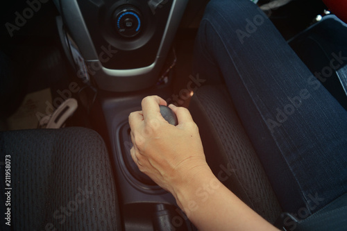 hand of adult man  handle with gear stalk in car while driving photo