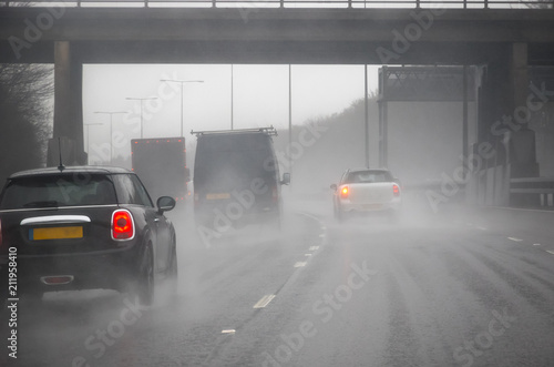 Driving on a motorway in a bad weather in England photo