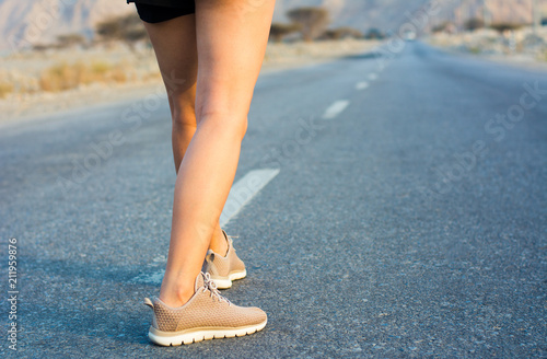 Female runner on the desert road