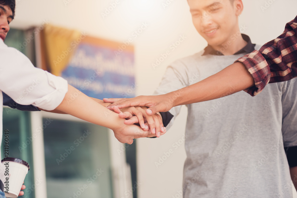 Group of cheerful students with holding hands in the campus, Students team celebrate victory success goal achievement happy smile,Education concept. Group of cheerful students with holding hands in the campus, Students team celebrate victory success goal achievement happy smile,Education concept.