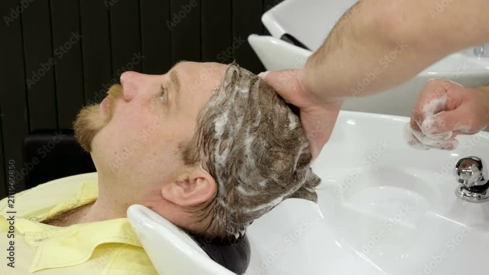 Preparation for haircut. Barber washing men's hair on the head in barbershop. 4K Preparation for haircut. Barber washing men's hair on the head in barbershop. 4K