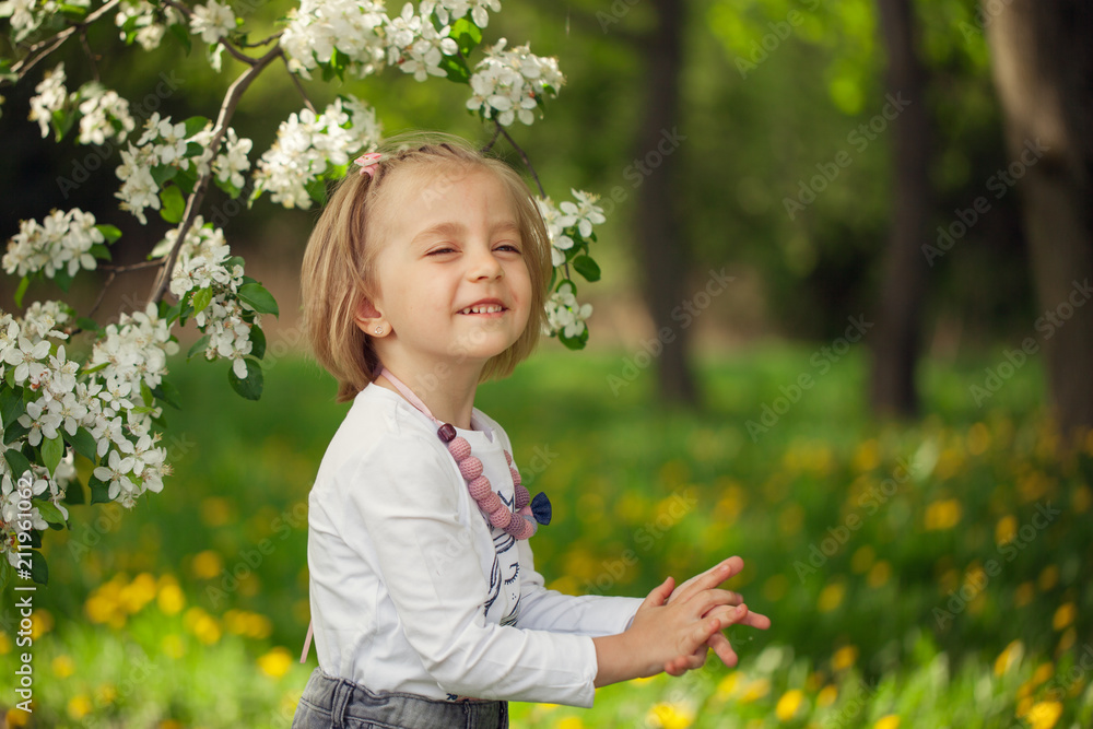 Lovely girl in a blooming apple orchard in sunny spring Lovely girl in a blooming apple orchard in sunny spring