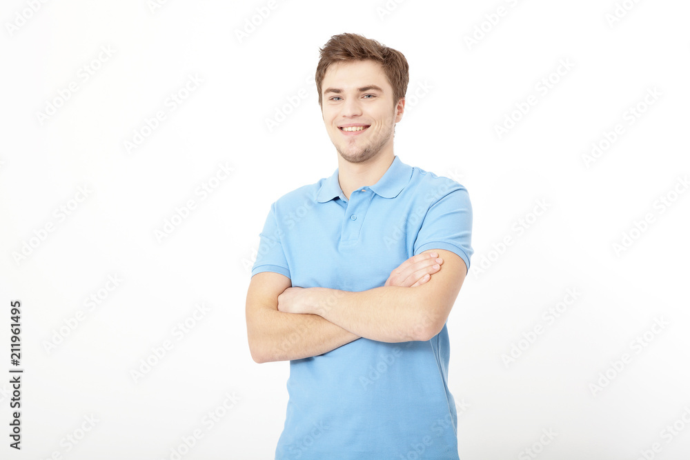 Smiling young man portrait isolated on white background. Copy space. Mock up. Handsome guy. Summer shirt clothes. Crossed arms Smiling young man portrait isolated on white background. Copy space. Mock up. Handsome guy. Summer shirt clothes. Crossed arms