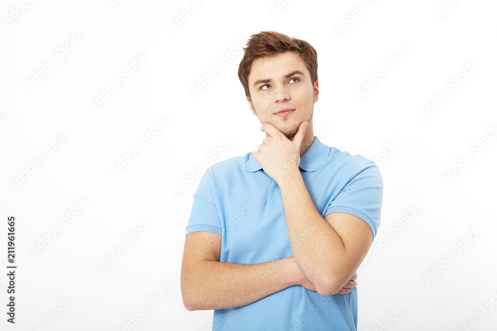 Thinking young man portrait isolated on white background. Copy space. Mock up. Handsome guy. Summer shirt clothes. Crossed arms Thinking young man portrait isolated on white background. Copy space. Mock up. Handsome guy. Summer shirt clothes. Crossed arms