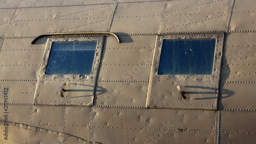 Obraz na plátně Two side windows of Douglas Dakota DC-3 C-47 WWII steel war plane exhibit in loc