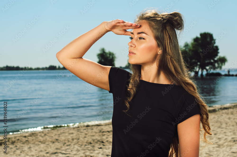 the athlete on the beach posing. blonde girl with big eyes posing