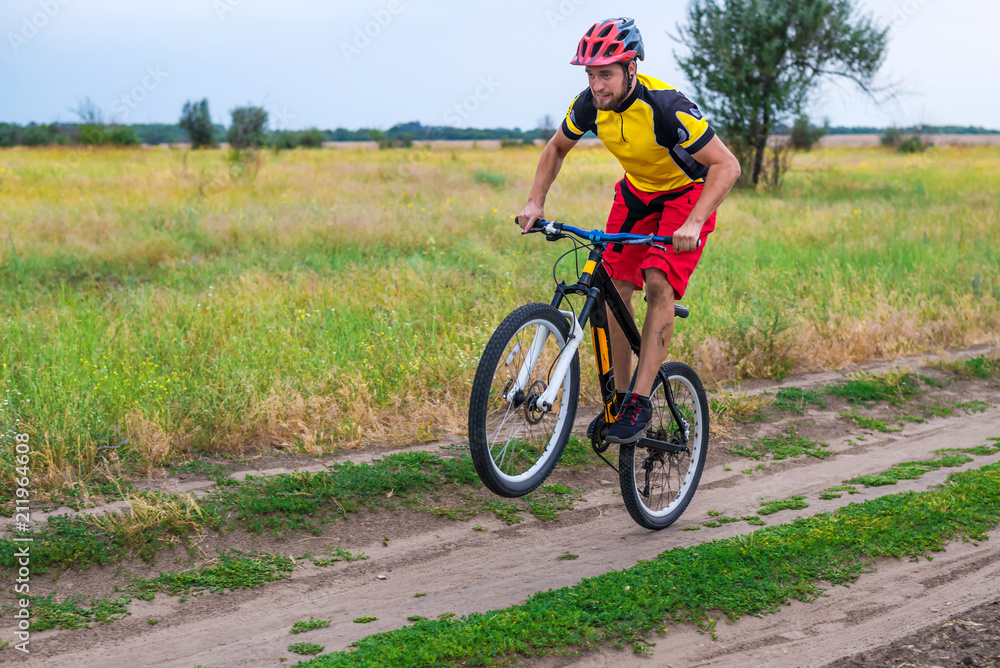 Cyclist riding on the rear wheel of the bicycle, active lifestyle.