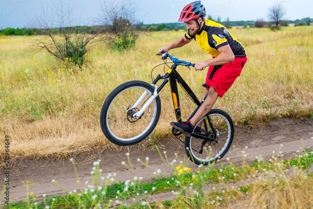 Cyclist riding on the rear wheel of the bicycle, active lifestyle. Cyclist riding on the rear wheel of the bicycle, active lifestyle.