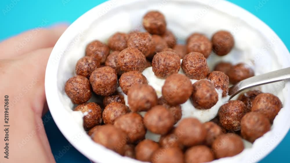 Jar of yogurt with spoon and chocolate balls On A Green Background Jar of yogurt with spoon and chocolate balls On A Green Background