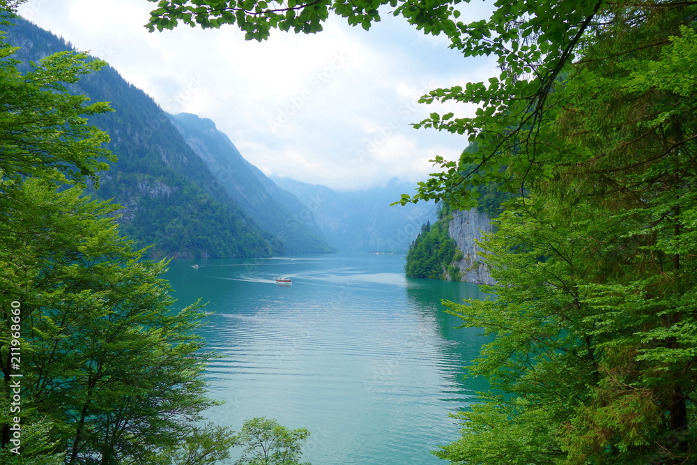 Stunning colorful waters of Konigsee known as Germany's deepest and cleanest lake, located in Berchtesgadener National Park, Upper Bavarian Alps, Germany. Stunning colorful waters of Konigsee known as Germany's deepest and cleanest lake, located in Berchtesgadener National Park, Upper Bavarian Alps, Germany.