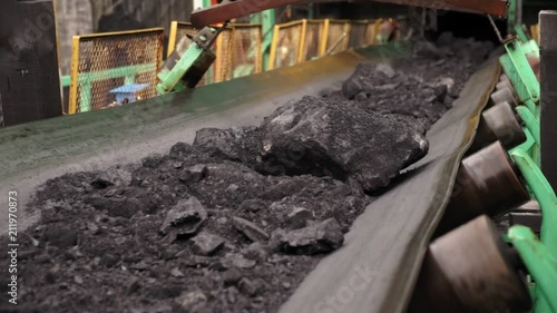 Coal on conveyor belt in rainy weather