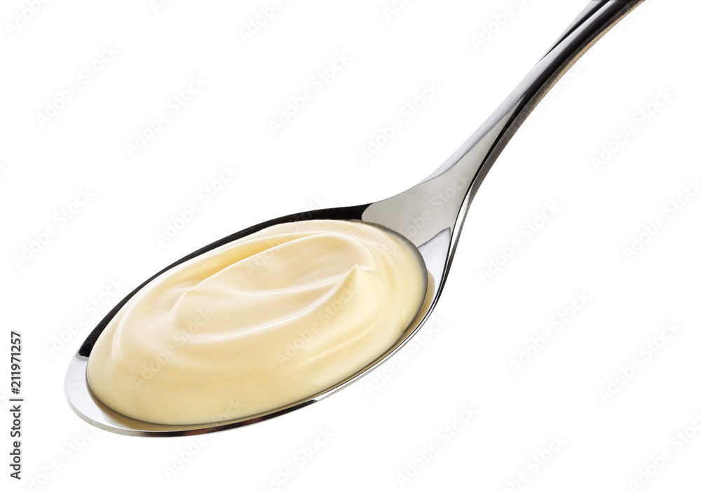 Sour cream in spoon isolated on white background with clipping path Sour cream in spoon isolated on white background with clipping path
